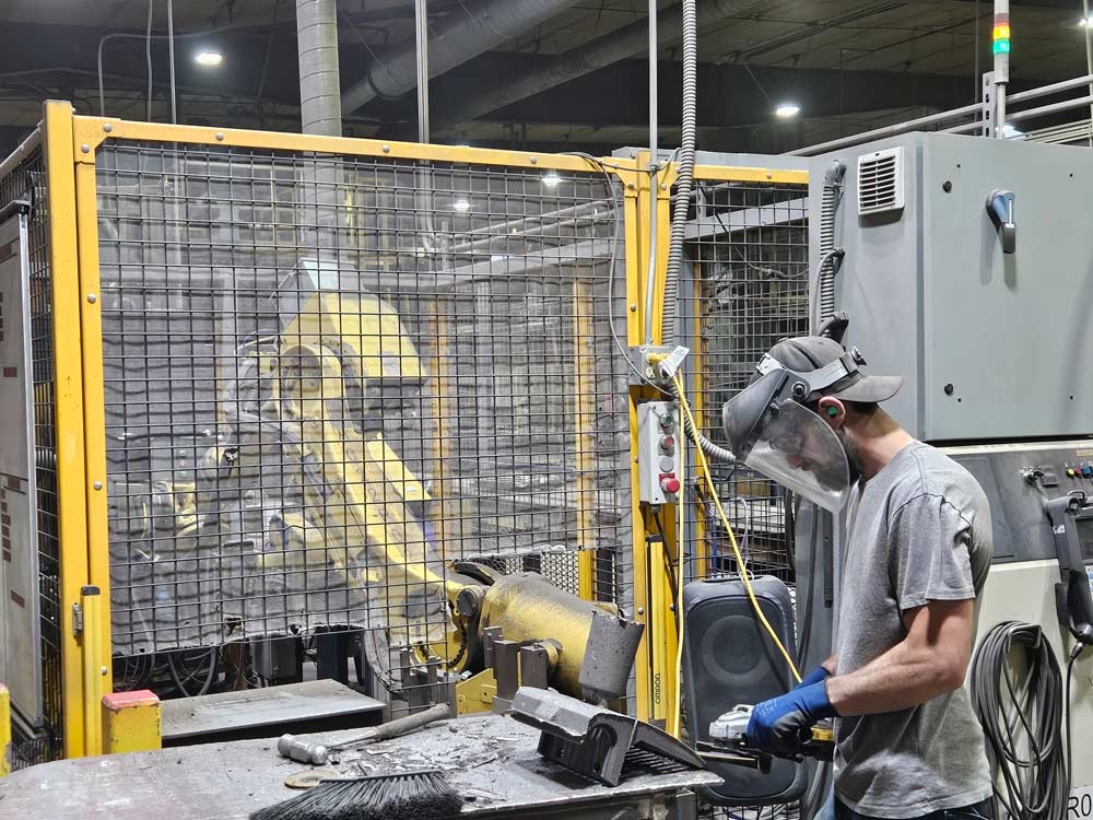 Employee grinding casted part, careers at Cast7